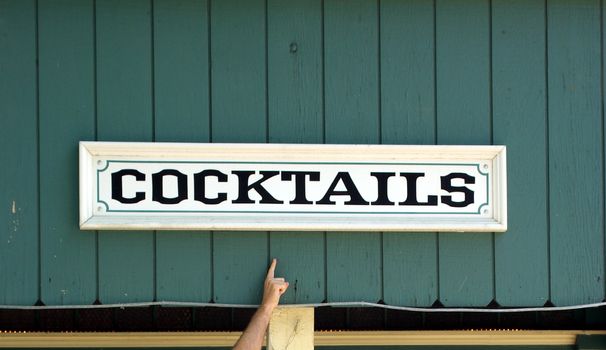 Hand Pointing To A Cocktail Sign