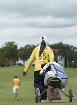 Golf caddie and player