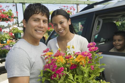 Couple Loading Plants into Minivan