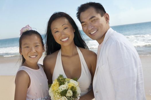 Bride and Groom With Sister on Beach