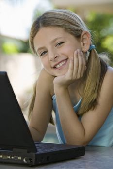 Girl Using Laptop on Patio