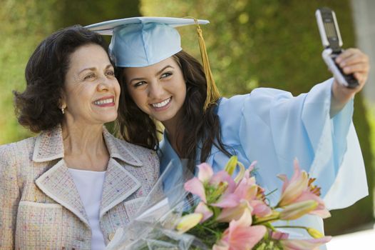 Graduate and Grandmother Taking Picture with Cell Phone