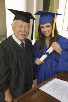 Graduate with Diploma next to Administrator