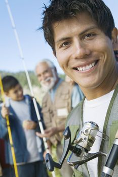 Smiling Man on Fishing Trip with Father and Son