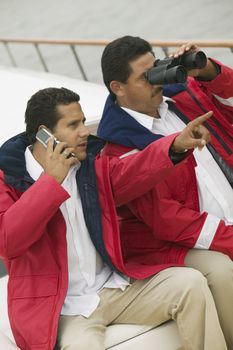 Men on Boat with Cell Phone and Binoculars
