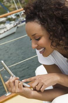 Woman Using Cell Phone on Boat