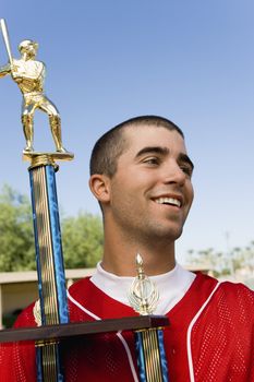 Baseball Player Holding Trophy