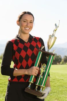 Golf Champion Holding Trophy
