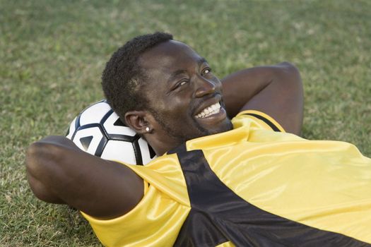 Soccer Player Using Ball as Pillow
