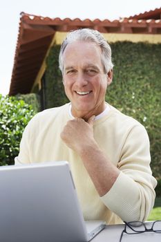 Man Using Laptop in Garden