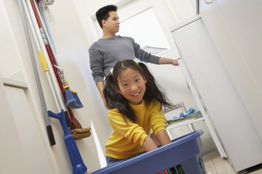 Man and Daughter Doing Laundry