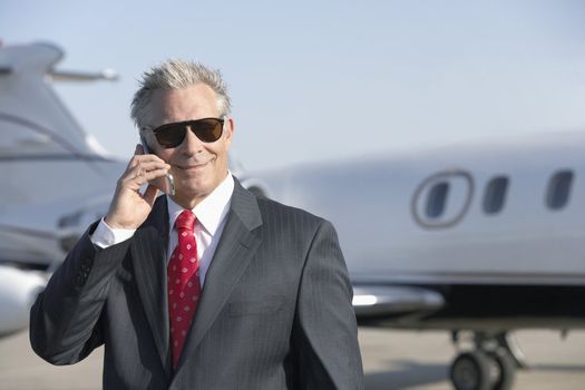 Business Man Beside an Airplane