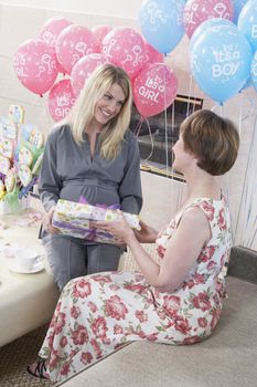 Woman Receiving a Gift at a Baby Shower