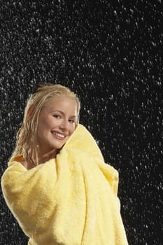 Woman Wrapped in Towel Standing in Rain
