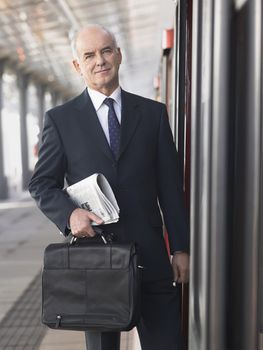 Businessman Standing in Train Station