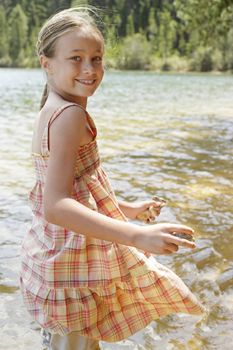 Girl Playing by Lake