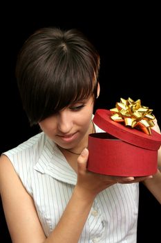 The young girl looks in a box with a gift