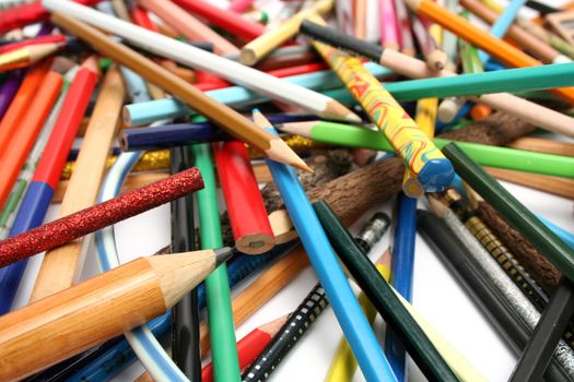 Heap of multi-colour pencils from a tree and plastic