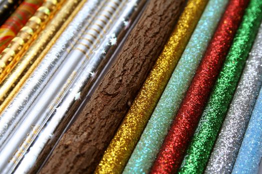 Unusual pencil made of natural wood among multi-coloured sparkling pencils horizontal