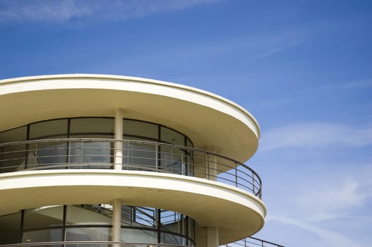 An Art-deco balcony against a blue sky