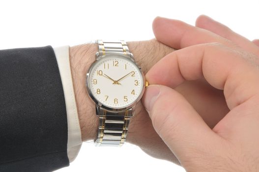 Right hand puts time on wristwatch left arm of the business men. White sleeve shirt peeking out from under the black sleeve of his jacket. iIsolated on White
