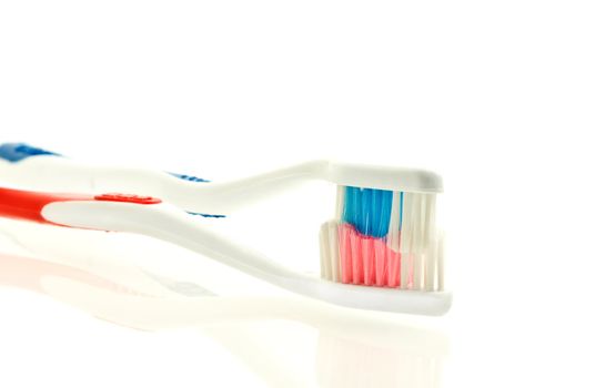 two toothbrushes for couple  over white. Shallow DOF. Focus on bristle.