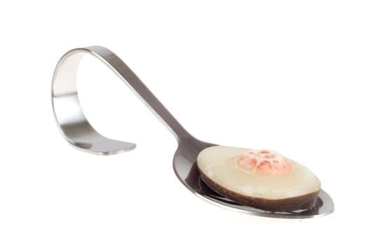 an appetizer spoon with a chocolate candy