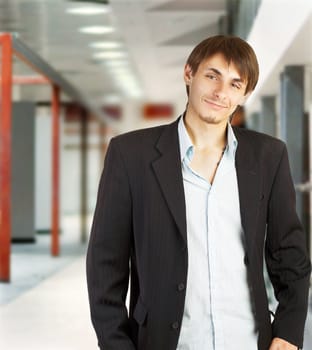 Young businessman walking in a corridor of a modern office building