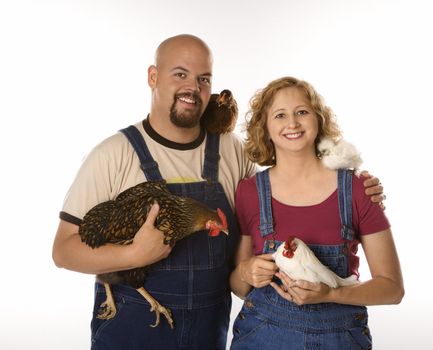 Caucasian mid-adult woman and man with chickens.