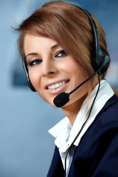 Beautiful representative smiling call center woman with headset.