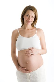 Pregnant woman holding exposed belly laughing