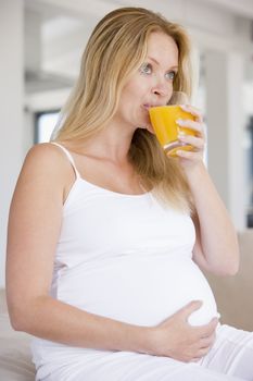 Pregnant woman with glass of orange juice