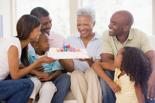 Family in living room with cake smiling