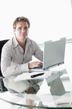 Businessman in boardroom with laptop