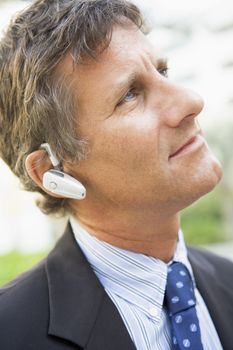Businessman wearing headset outdoors