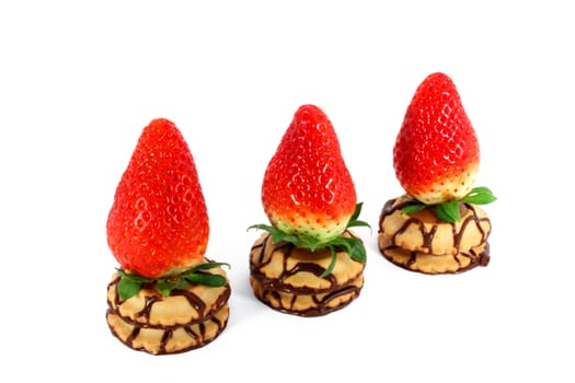Three fresh strawberries on a cakes