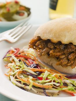 Pulled Pork and Barbeque Sauce Roll with Seeded Slaw and Gherkin