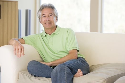 Man sitting in living room smiling