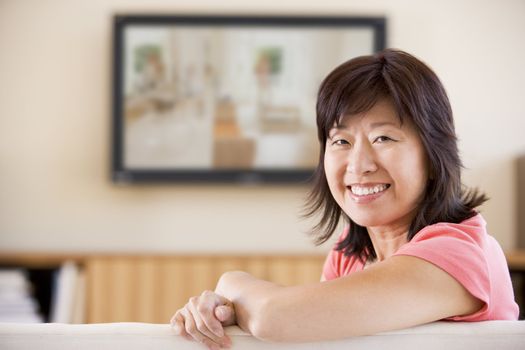 Woman watching television smiling