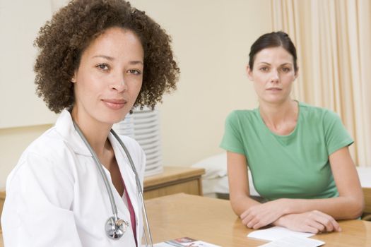 Woman in doctor's office frowning