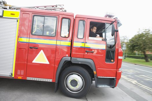 A fire engine leaving the fire station