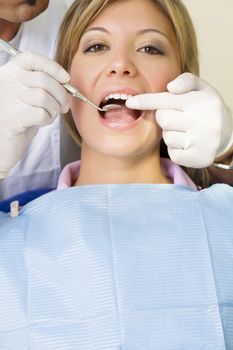 dentist using an angled mirror. Copy space. The focus is on woman's teeth