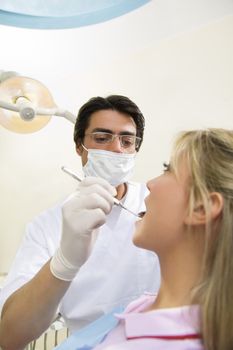 dentist holding an angled mirror