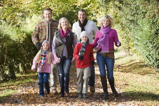 Family walking outdoors in park smiling