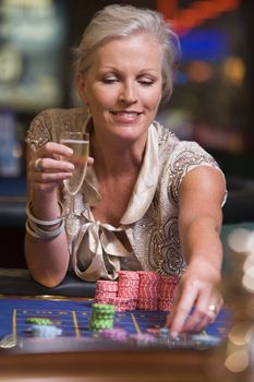 Woman in casino playing roulette