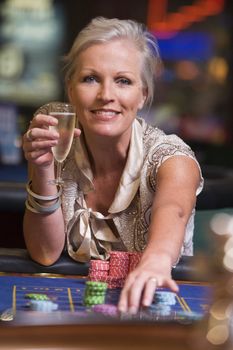 Woman in casino playing roulette