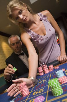 Couple in casino playing roulette 