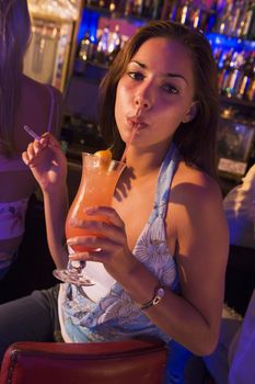 Young woman in a bar smoking 