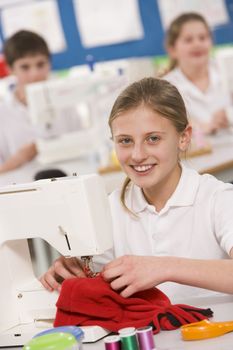 Female student using sewing machine 