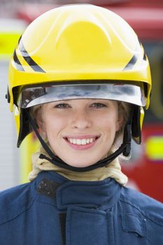 Firewoman standing by fire engine 